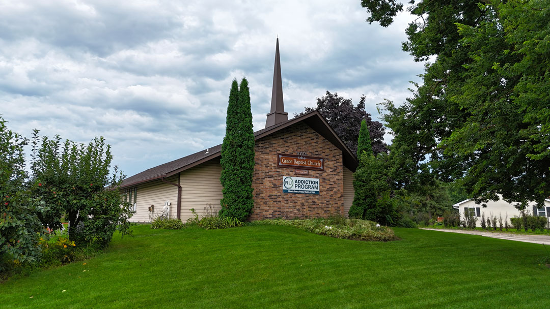 Front of church building with church sign